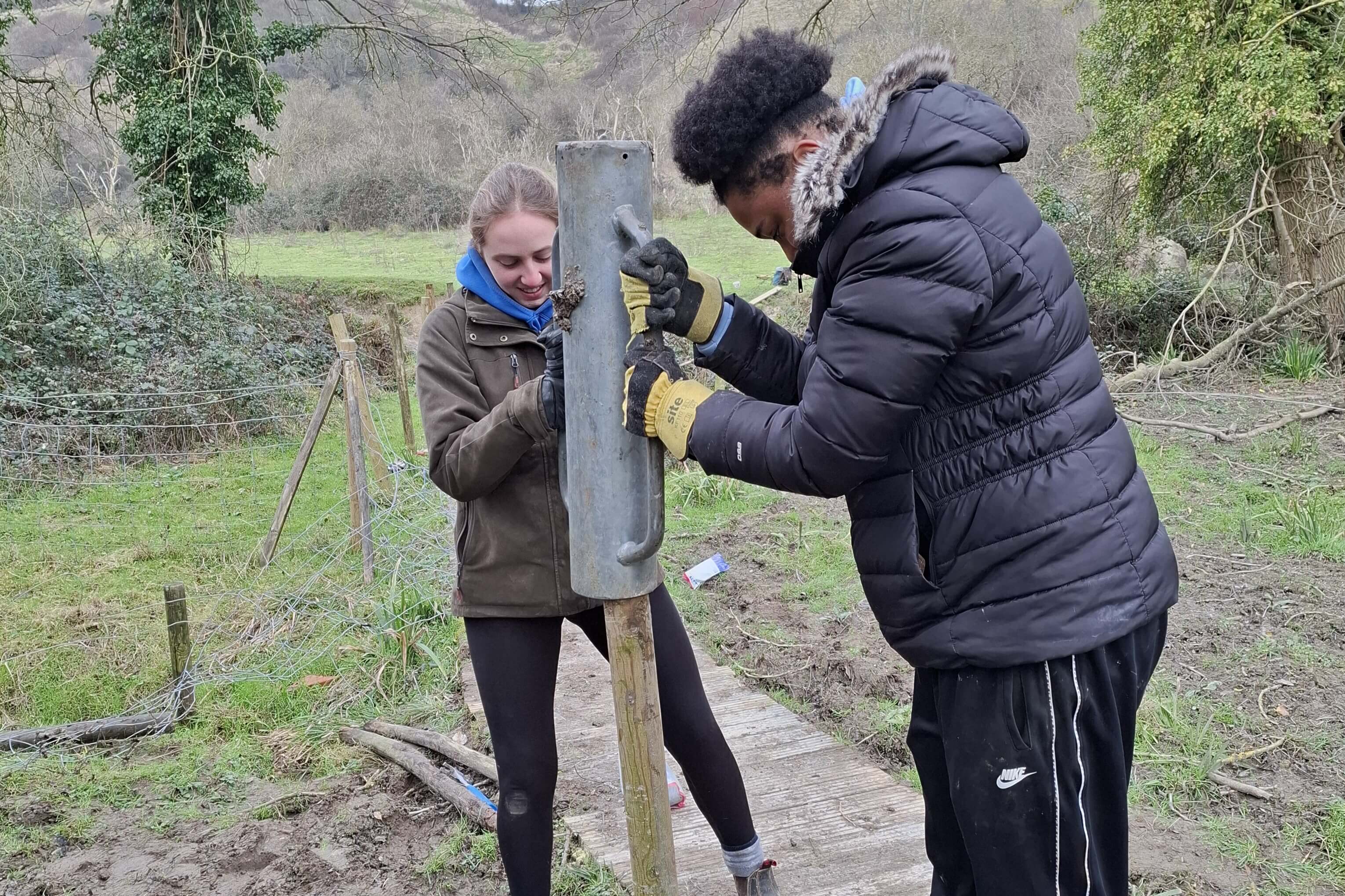 Wild Futures attendees helping with boardwalk repairs at Folkestone Downs.