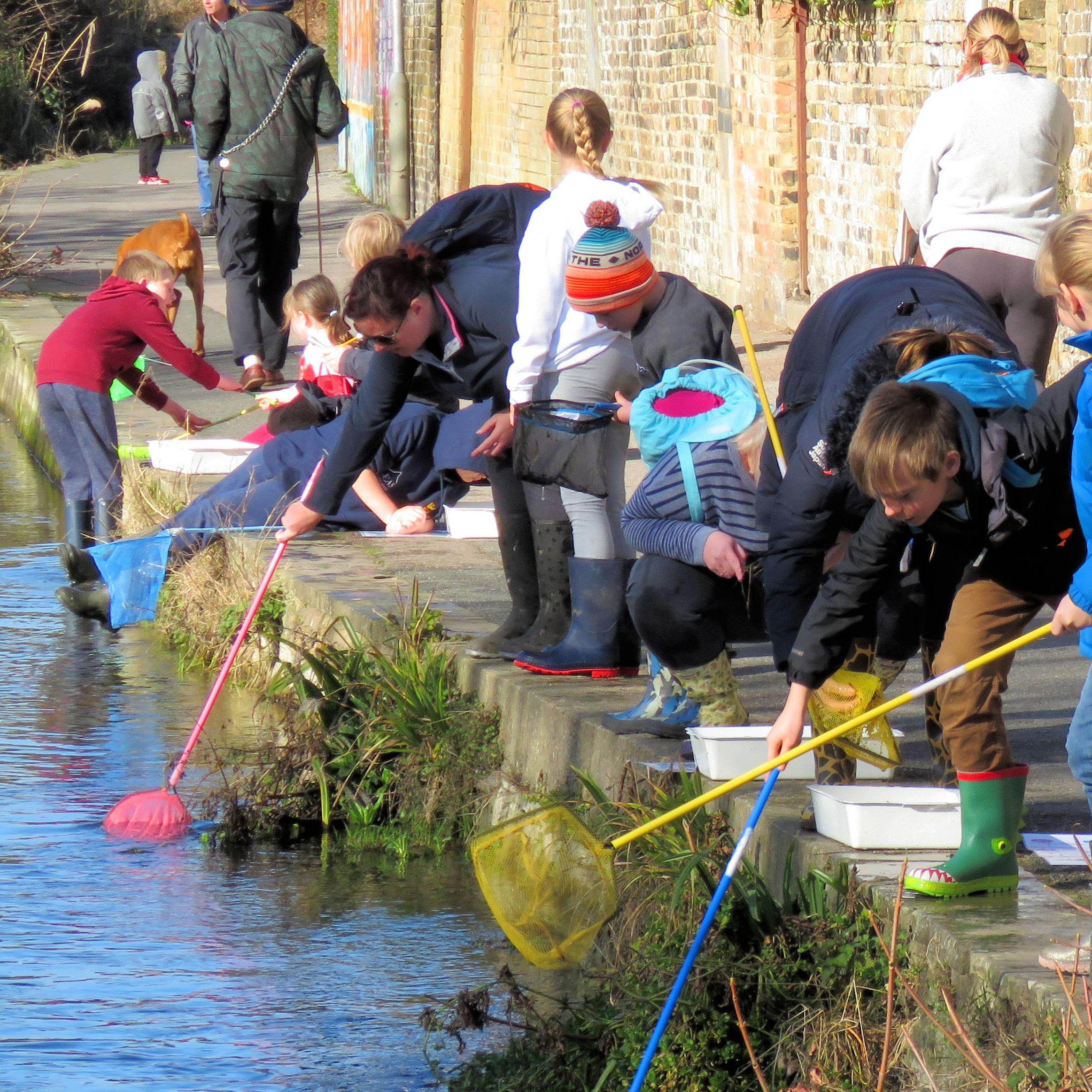 People river dipping on the River Dour