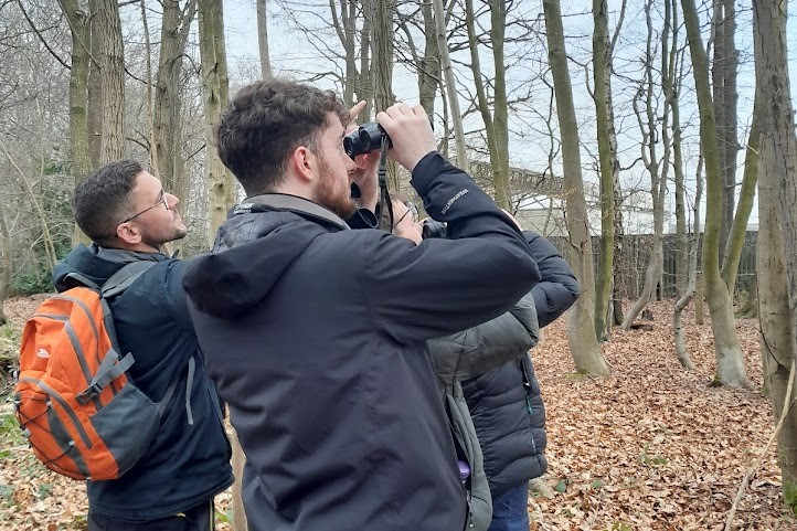 Ranger Jason pointing out wintering bird species to Wild Futures attendees.